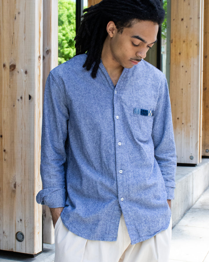 Indigo chambray button-up shirt with patchwork by Kiriko Made